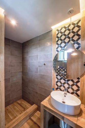 a bathroom with a sink and a mirror at Asteris Village in Gerakini