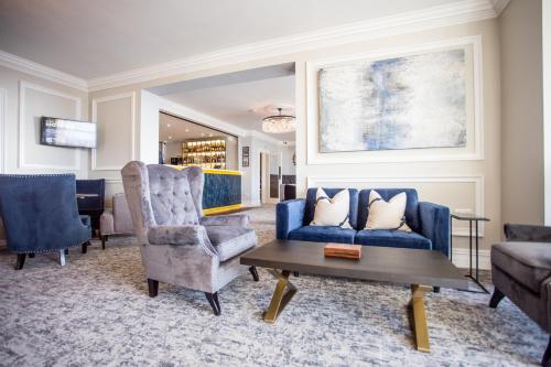 a living room with a blue couch and a table at Doric Hotel in Blackpool