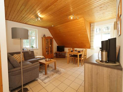 a living room with a couch and a tv at Landferienhof Garbert in Wilsum