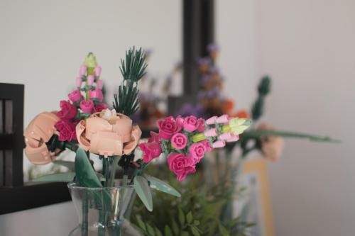 アルルにあるAteliers, Terrasse - Parking - Climのテーブルの上にピンクの花が咲き誇るガラスの花瓶