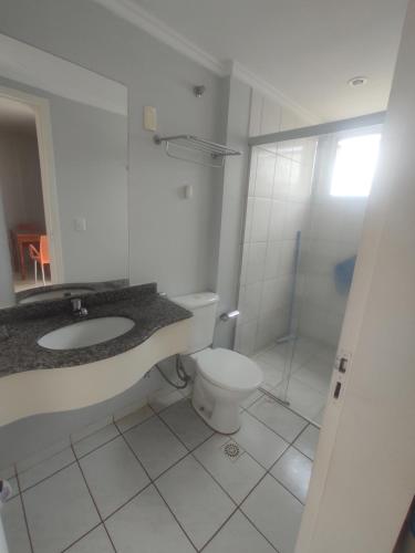 a bathroom with a toilet and a sink and a shower at Suíte Thermas Place in Caldas Novas