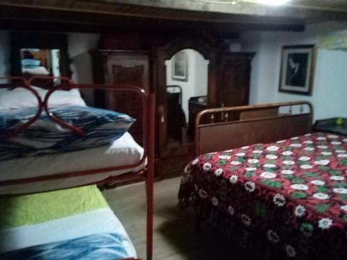 a bedroom with two bunk beds in a room at Baita 7 Nani in Pievepelago