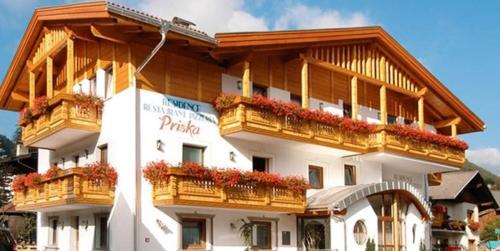 a large building with balconies and flowers on it at Residence Priska in Racines
