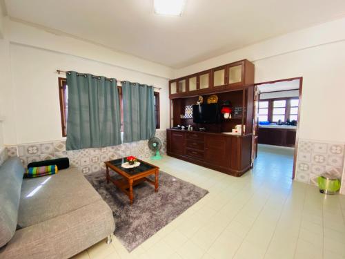 a living room with a couch and a coffee table at Ma Baan House by the sea in Cha Am Beach