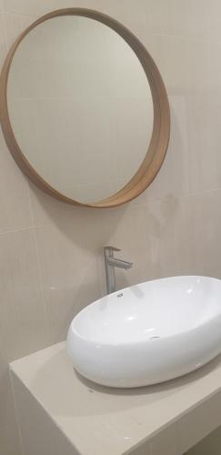 a bathroom with a white sink and a mirror at HOTEL CIPUNAGA in Sukabumi