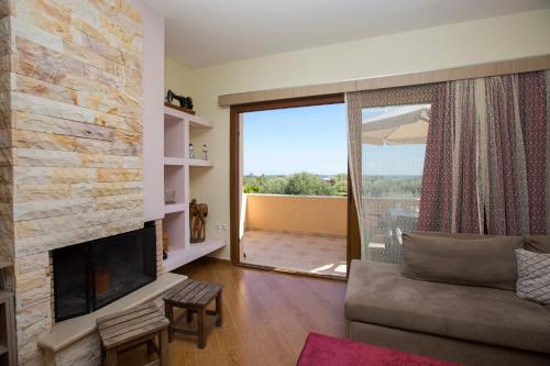 a living room with a couch and a fireplace at Serenity Sea-View Home in Afantou