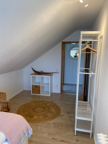 a attic room with a ladder and a table at Appartement Am Waldweg in Achern