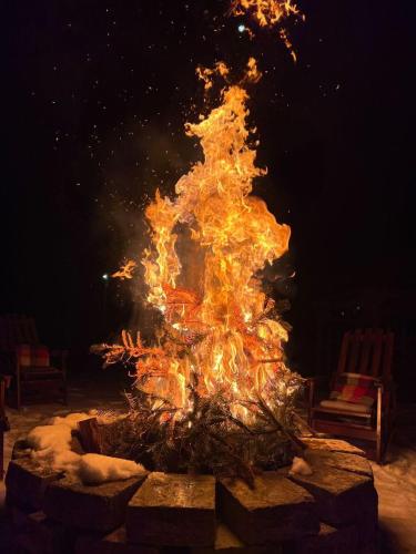 a large fire pit with flames in it at Craita Merelor The PLACE in Aninoşani