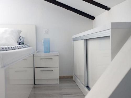 a white room with a bed and a glass door at Apartments Blue Lavender in Cres
