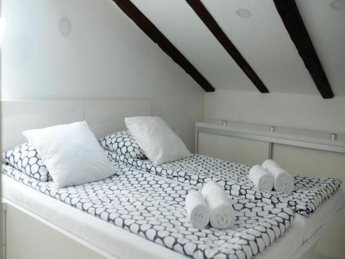 a white bed with pillows and towels on it at Apartments Blue Lavender in Cres