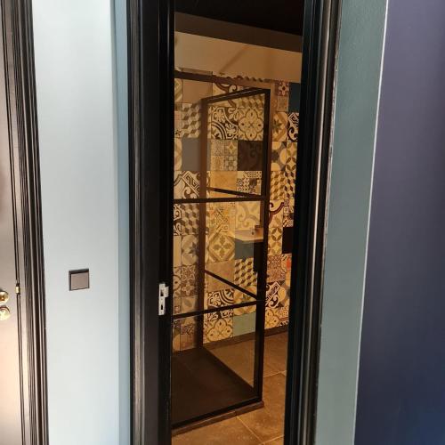 a glass door leading into a wine cellar at VET - Bed & Breakfast in Beek