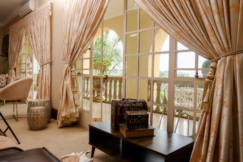 a living room with a table and a window at TDM's Boutique Guest House in Pretoria