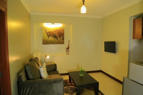 a living room with a couch and a table at Royal Victoria House Ltd in Kampala