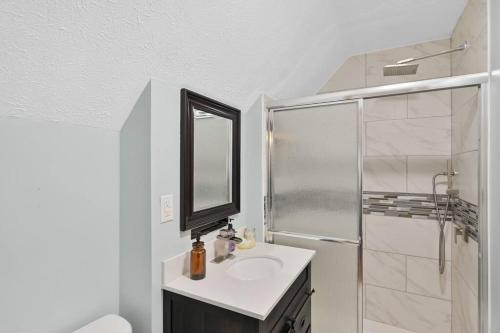 a bathroom with a sink and a shower with a mirror at Poconos Peaceful Retreat - Families & Large Groups in Tobyhanna