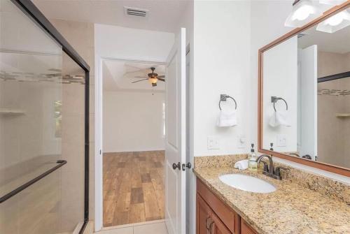 a bathroom with a sink and a shower at Modern, Upscale, and New Blue Bungalow in the heart of Downtown St Augustine in St. Augustine