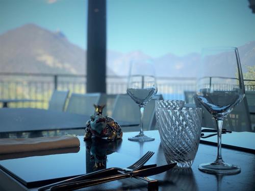 a table with wine glasses on a table on a balcony at Pernice 77 in Sulzano