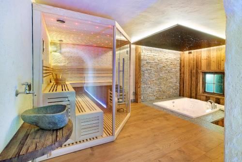 a bathroom with a large tub and a shower at Le Chalet Suite in Livigno