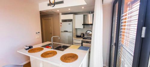 a kitchen with a counter with two sinks and a refrigerator at Ultra Lux Residence Flat-Great LocationB1 in Istanbul