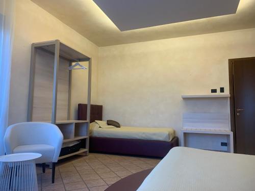 a room with two beds and a table and chairs at Pernice 77 in Sulzano