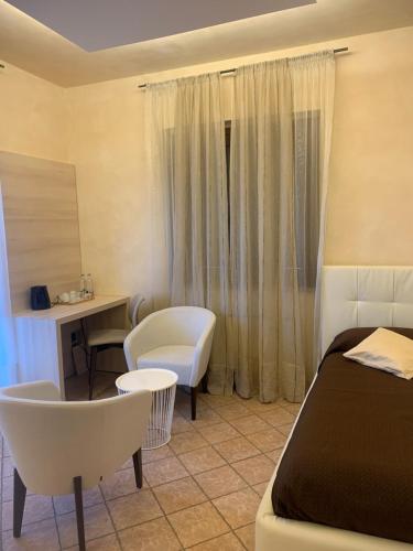 a bedroom with a bed and a table and chairs at Pernice 77 in Sulzano