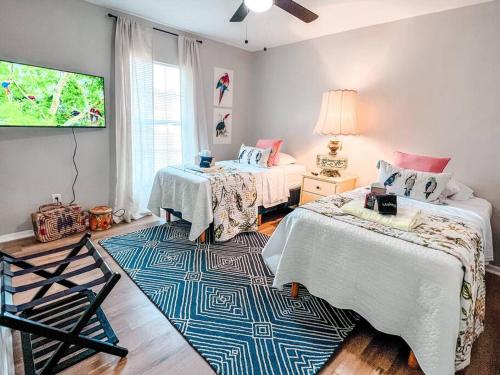 a bedroom with two beds and a rug at Relax in Style at Our 3BR 2BA Retreat with Private Pool, Game Room, Fire Pit, Yoga in Tampa