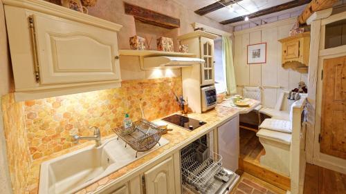 a kitchen with a sink and a counter top at Remparts de Riquewihr - Refuge du Lutin - Studio in Riquewihr