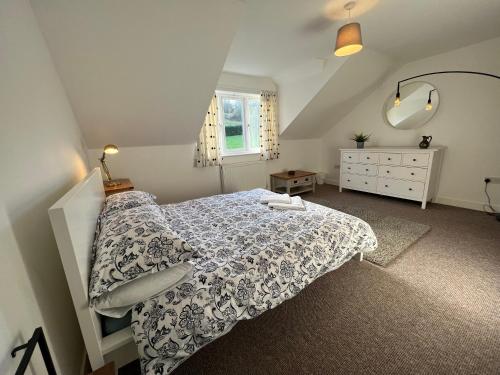 a bedroom with a bed and a dresser and a window at Town House B in Dunston
