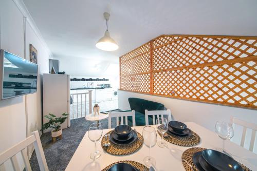 a dining room with a table with wine glasses on it at Elegant 4BR Little Venice By Aureva Residences in London
