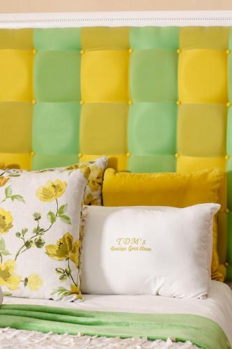 a bed with a yellow and green headboard at TDM's Boutique Guest House in Pretoria