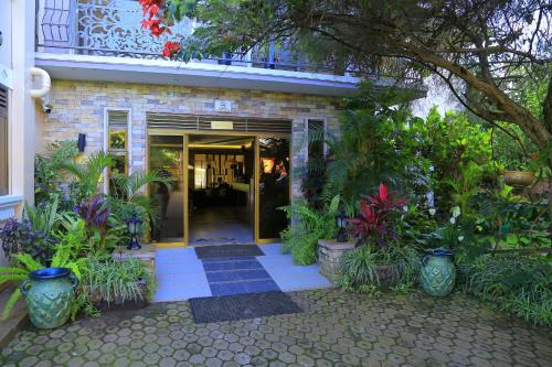 an entrance to a building with a bunch of plants at Royal Victoria House Ltd in Kampala