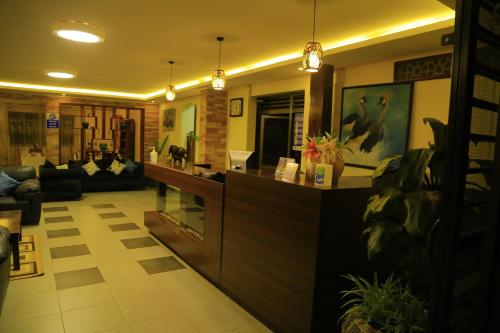 a lobby with a living room with a counter at Royal Victoria House Ltd in Kampala