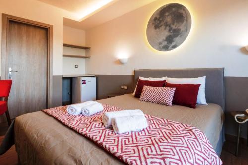 a bedroom with a large bed with towels on it at Asteris Village in Gerakini