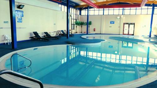 a large swimming pool in a large building at Ocean View Hotel in Shanklin