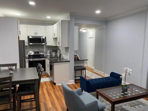 a living room with a kitchen and a dining room at Spacious Apartment in Boston in Boston