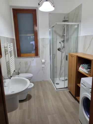 a bathroom with a shower and a toilet and a sink at Casa Vacanze Maurella in Marconia