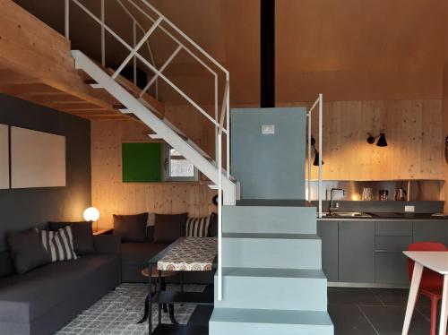 a staircase leading up to a living room and kitchen at Maison 4 petite Casa design nel parco naturale in Crodo