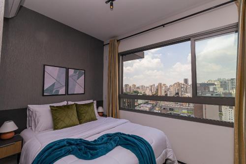 a bedroom with a bed and a large window at Vossa Bossa Allianz in Sao Paulo