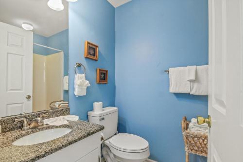 a blue bathroom with a toilet and a sink at Lighthouse II Unit 6 in Myrtle Beach