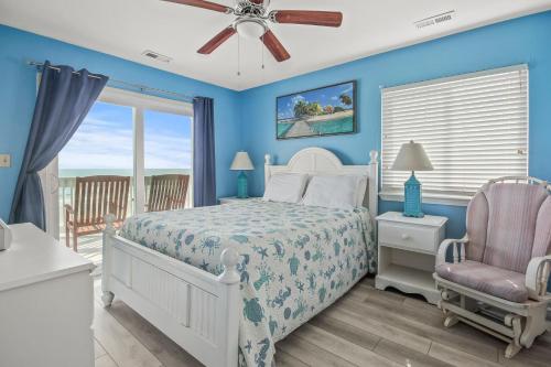 a blue bedroom with a bed and a chair at Lighthouse II Unit 6 in Myrtle Beach