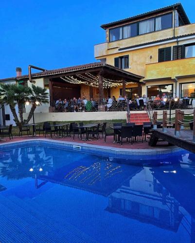 a large swimming pool in front of a building at Hotel La Ciaccia in Valledoria