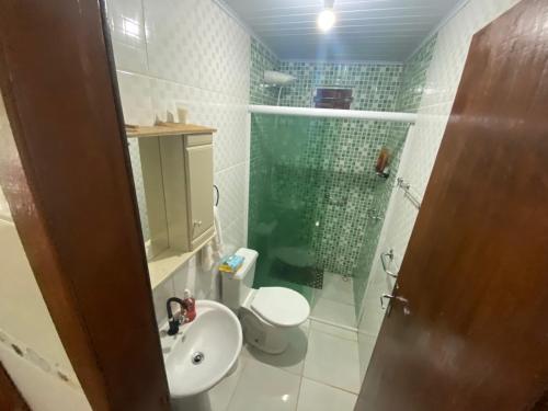 a bathroom with a shower and a toilet and a sink at Casa na praia de Itajuba in Barra Velha