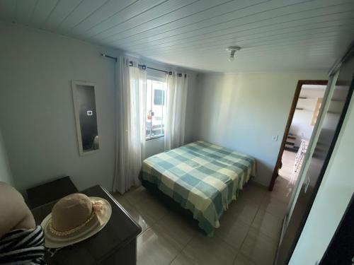 a small bedroom with a bed and a window at Casa na praia de Itajuba in Barra Velha