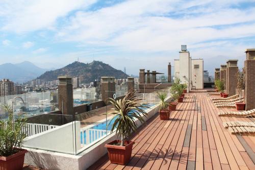 a balcony with plants and a view of a city at VIP Apartments Chile in Santiago