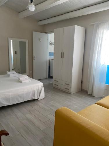 a large room with two beds and a cabinet at Casa vacanza il "Vignale" in Portopalo