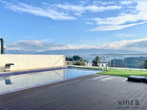 a swimming pool on the roof of a house at Casa do Golfe by VinteOito in Amarante