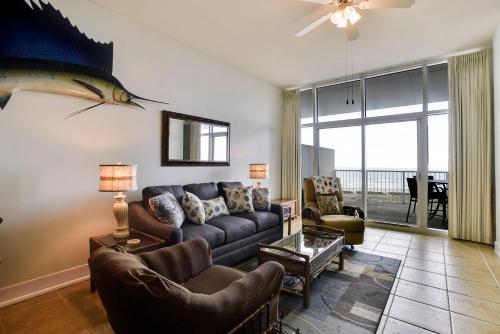 a living room with a couch and a fish on the wall at Emerald 1111 in Galveston