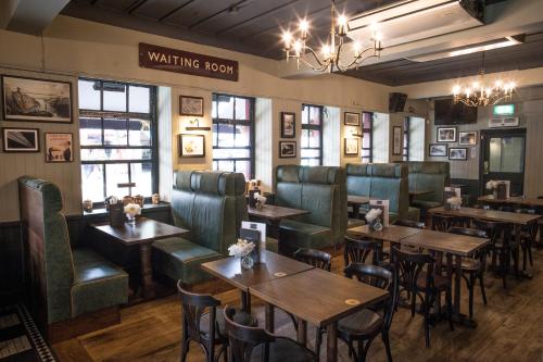 a restaurant with tables and chairs and a waiting room at The Pride of Paddington in London