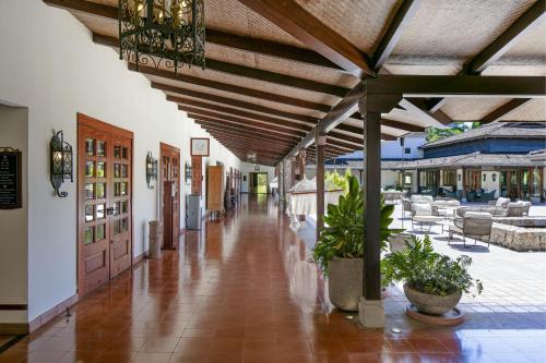 a hallway of a resort with tables and chairs at JW Marriott Guanacaste Resort & Spa in Tamarindo