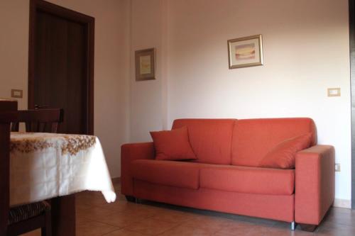 a red couch sitting in a living room at Miralago Lorica in Lorica