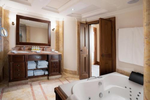a bathroom with a tub and a sink at Castillo Hotel Son Vida, a Luxury Collection Hotel, Mallorca in Palma de Mallorca